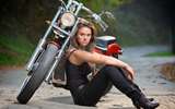 3909061-biker-girl-sitting-next-to-a-bike